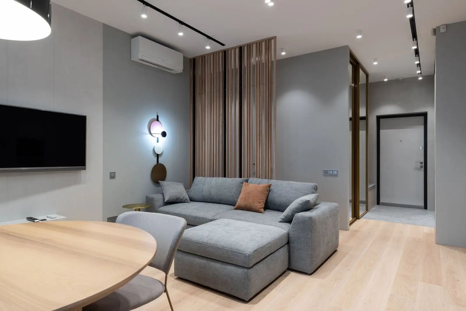 White wall-mounted split-system air conditioner in a bright, modern living room